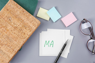 Paper sheets with written text and stationery on grey background. Management concept © Africa Studio