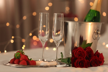 Romantic composition with champagne and strawberry on blurred background. Honeymoon concept