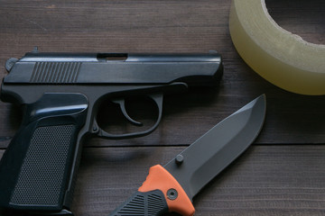 criminal news equipment. gun, knife, duct tape