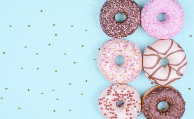 Colorful donuts on blue background.