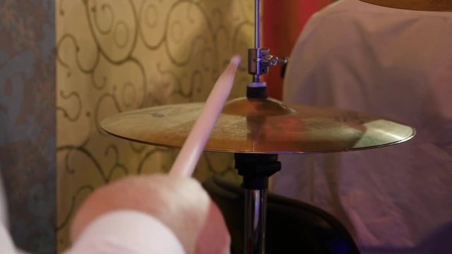drummer beats the hi-hat drum sticks on live concert Slow motion close-up