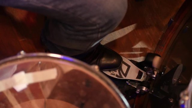 Closeup of drummer's foot moving drum bass pedal. Drumming on Stage. Slow motion