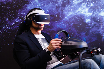 Man with VR glasses of virtual reality. A boy in virtual augmented reality helmet. VR headset. Future technology concept