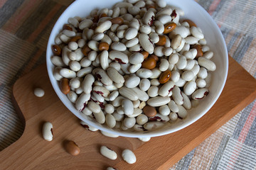 Close-up of a bean in a bowl on a wooden plank background
