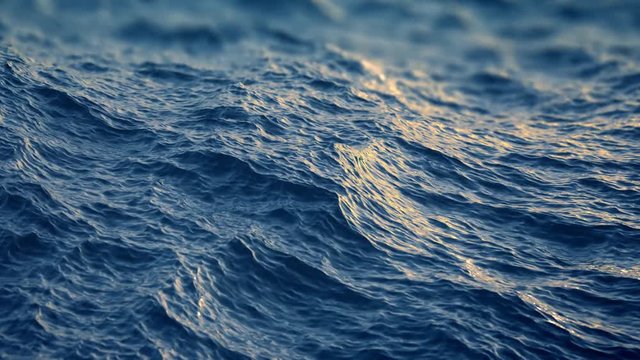 Slow motion close up of  disturbed blue ocean water surface
