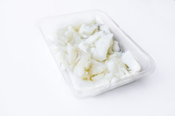 Packed tray with desalted slices of codfish
