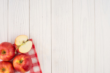 Red apples on the old wooden table.