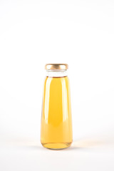 Small glass bottle of apple juice. Fruit drink in a bottle isolated on white background
