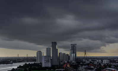 Naklejka premium Thundercloud spreading over Bangkok before heavy raining pouring in the evening , Thailand