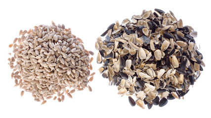 Sunflower seeds - pile of the kernels and pile of the husks isolated on white.