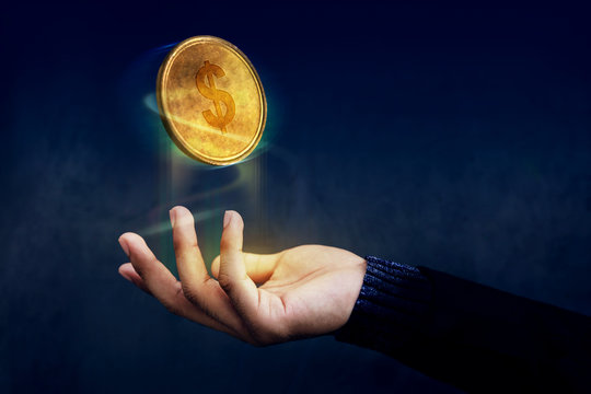 Financial or Profit as Easy Concept, Golden Money Coin float over Magician hand like a Magic, Dark light