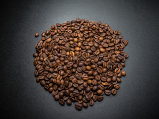 Roasted coffee beans on dark background. Selective focus.