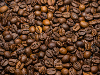 Roasted coffee beans on dark background. Selective focus.