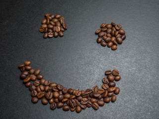 Roasted coffee beans on dark background. Selective focus.