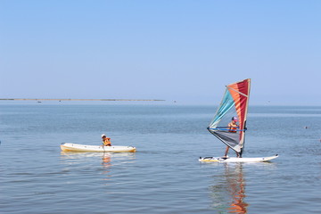 Boy surfer in the sea in the morning 