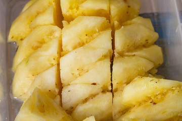 Pineapple fruit cut on chopping board