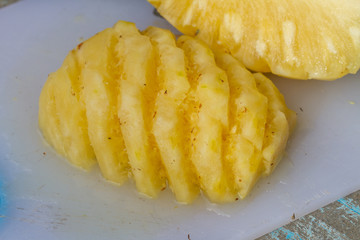 Pineapple fruit cut on chopping board