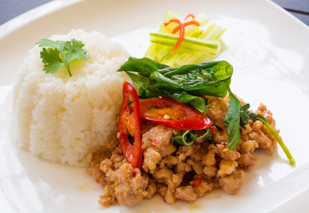 fired pork with hot basil leave on white plate