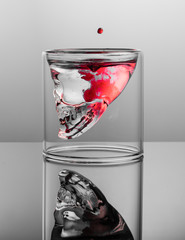 Dark thoughts. Negative with red stains in the glass skull