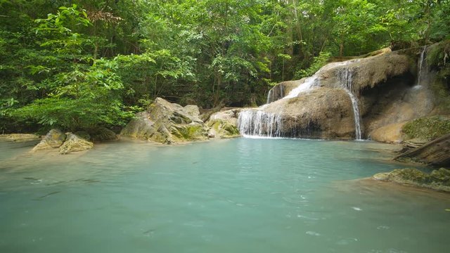 4k video of Level 1 of Erawan Waterfall with Neolissochilus stracheyi fish in Kanchanaburi Province, Thailand