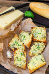Bread baguette baked with grated cheese and garlic