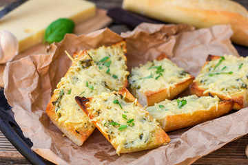 Bread baguette baked with grated cheese and garlic
