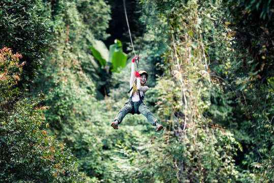 Woman Going On A Jungle Zip Line Adventure, Asia