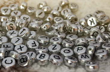  The discarded alphabet of beads on cloth