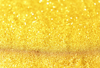 Gold glittering christmas lights. Blurred abstract background