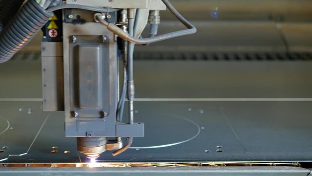 Laser cut machine while cutting the sheet metal with sparking light and high precision 
