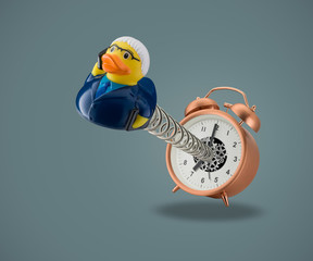rubber duck business man on spring coming out of alarm clock