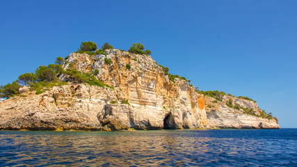 Fototapeta na wymiar Coastal scene from a boat off the south coast of Menorca in Spain