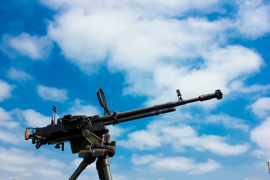 A machine gun against blue skies