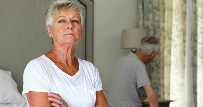  Upset senior couple arguing with each other in bedroom