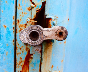 Closeup of old lock on blue metal garage door