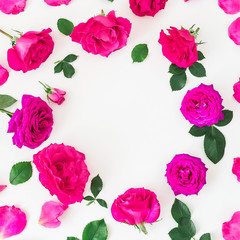 Floral round frame of pink roses and leaves on white background. Flat lay, top view. Pink floral composition