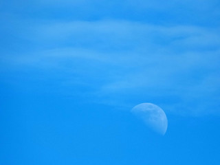 Naklejka na ściany i meble faint moon and clouds in a blue sky