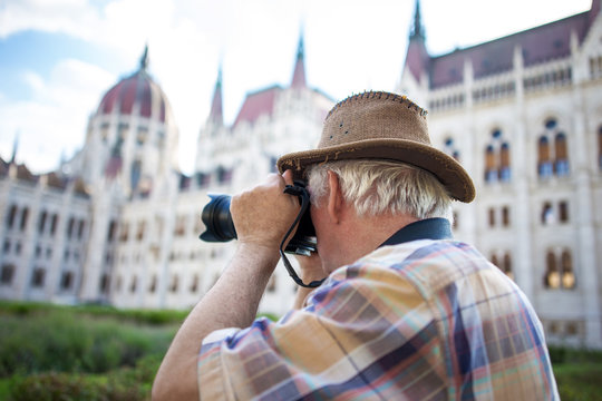 Senior Pensioner Photographing Parliament Building Budapest