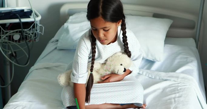Girl drawing picture in a book