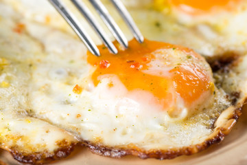 Flat lay closeup macro fried chicken eggs on the plate above wooden table