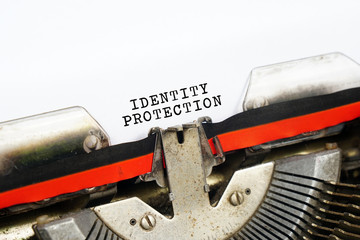 Vintage typewriter on white background with text IDENTITY PROTECTION