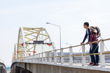 Male tourists enjoy the bridge.
