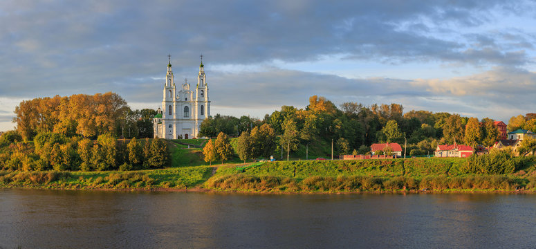 The Cathedral of St. Sophia and part of the city over the river by the light of the setting sun. The ancient town of Polotsk ( 862) is located in the center of Europe - Belarus. Panorama.