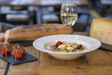 A plate of risotto with parmesan and chicken