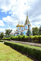 Ciuflea monastery sf teodor tiron, Chisinau, Moldova, sunny day blue sky trees and flowers