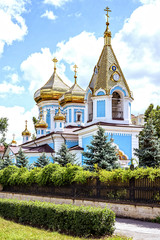 Fototapeta na wymiar Ciuflea monastery sf teodor tiron, Chisinau, Moldova, sunny day blue sky trees and flowers