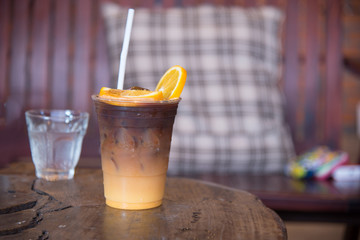 Colombia ice coffee mixed with orange juice on topping a piece of fresh orange
