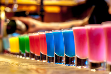 Colorful cocktails on a bar stand