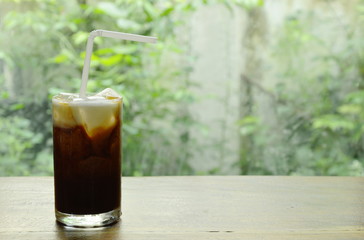 ice coffee topping milk floating with straw in glass