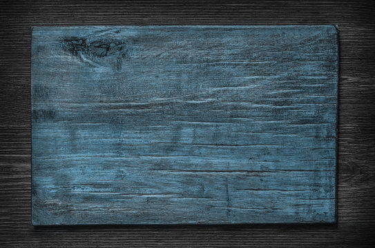 Fototapeta Blue wooden board on a dark wooden background